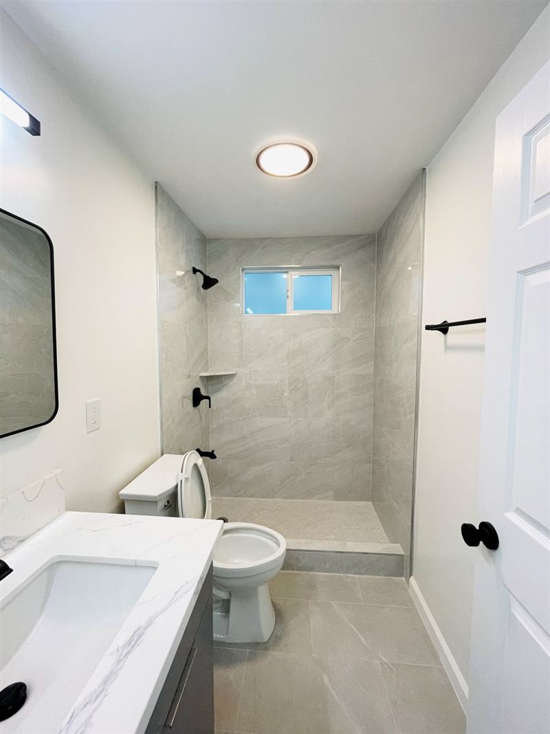 Finished bathroom with tiled shower